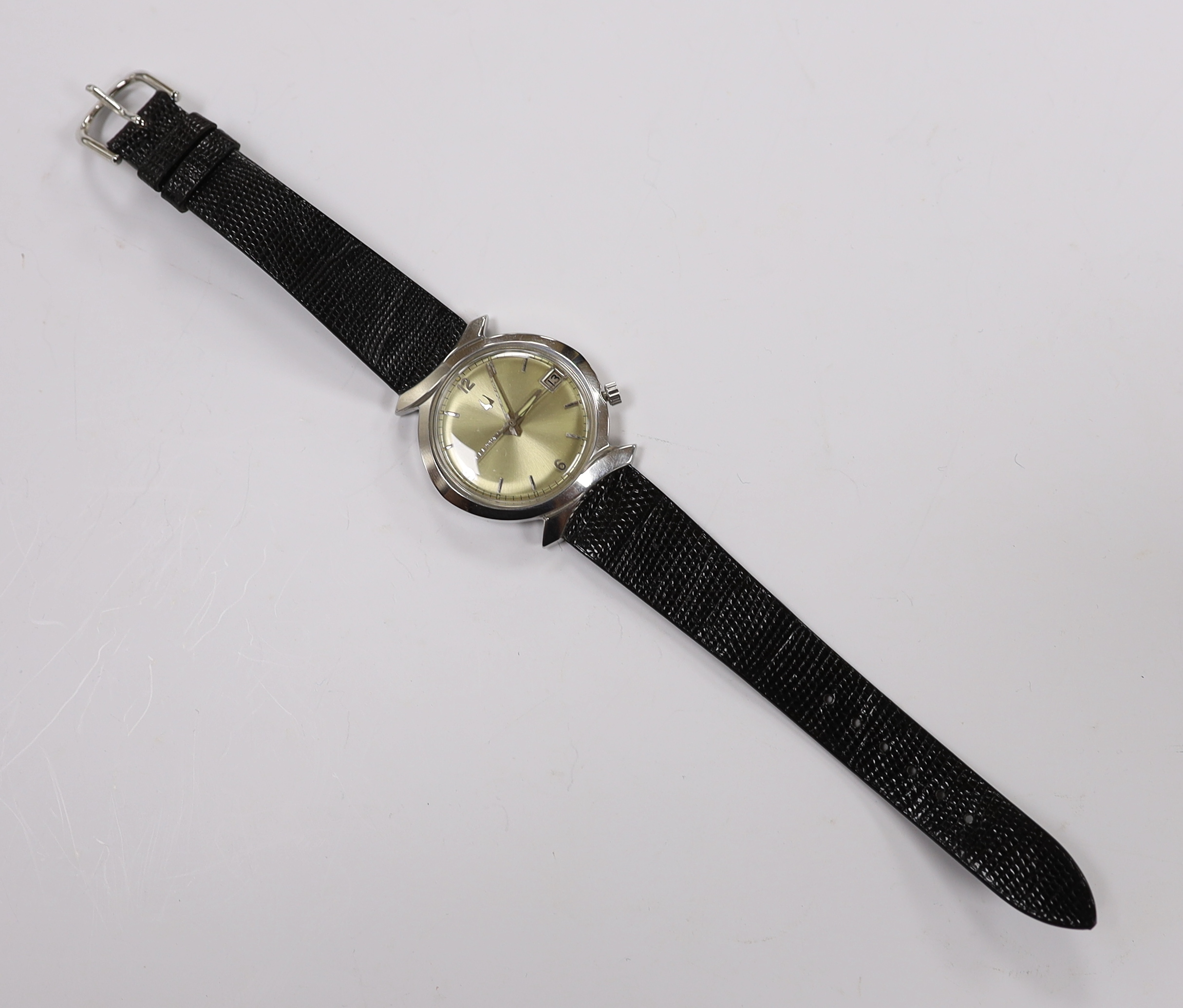 A gentleman's stainless steel Bulova Accutron wrist watch, with pale yellow dial, on Accutron strap, case diameter 36mm.